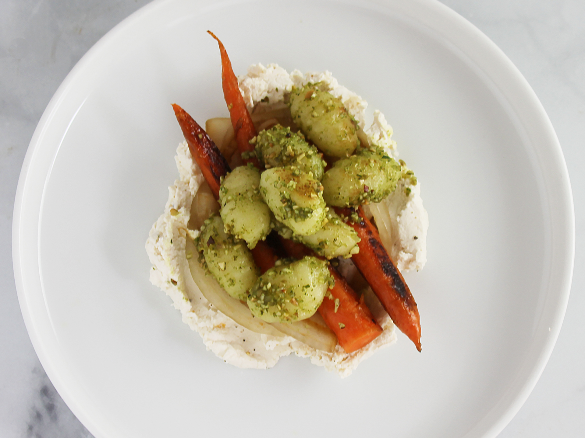 Pan Roasted Carrots with Caramelized Onions, Gnocchi, Herb Pesto and Whipped Ricotta